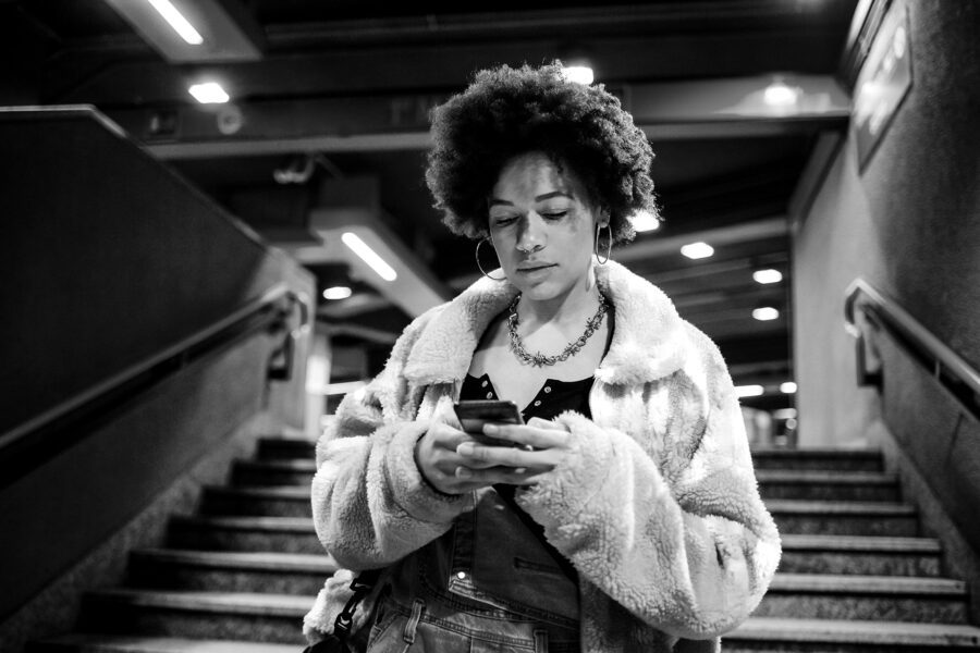 a young woman using a mobile responsive website to order things from an online store