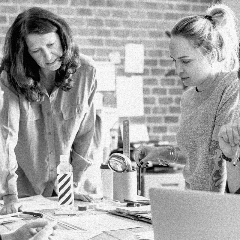 Creative agency team collaborating seamlessly in a modern workspace, combining expertise in design, development, and strategy to create impactful websites.