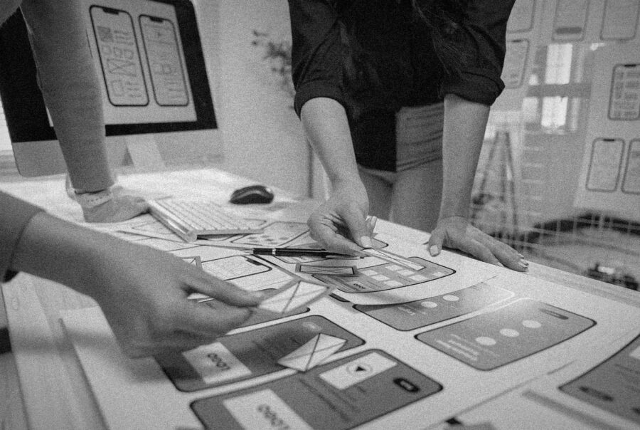 Creative agency team designing a mobile-optimized website with exceptional user experience strategies.