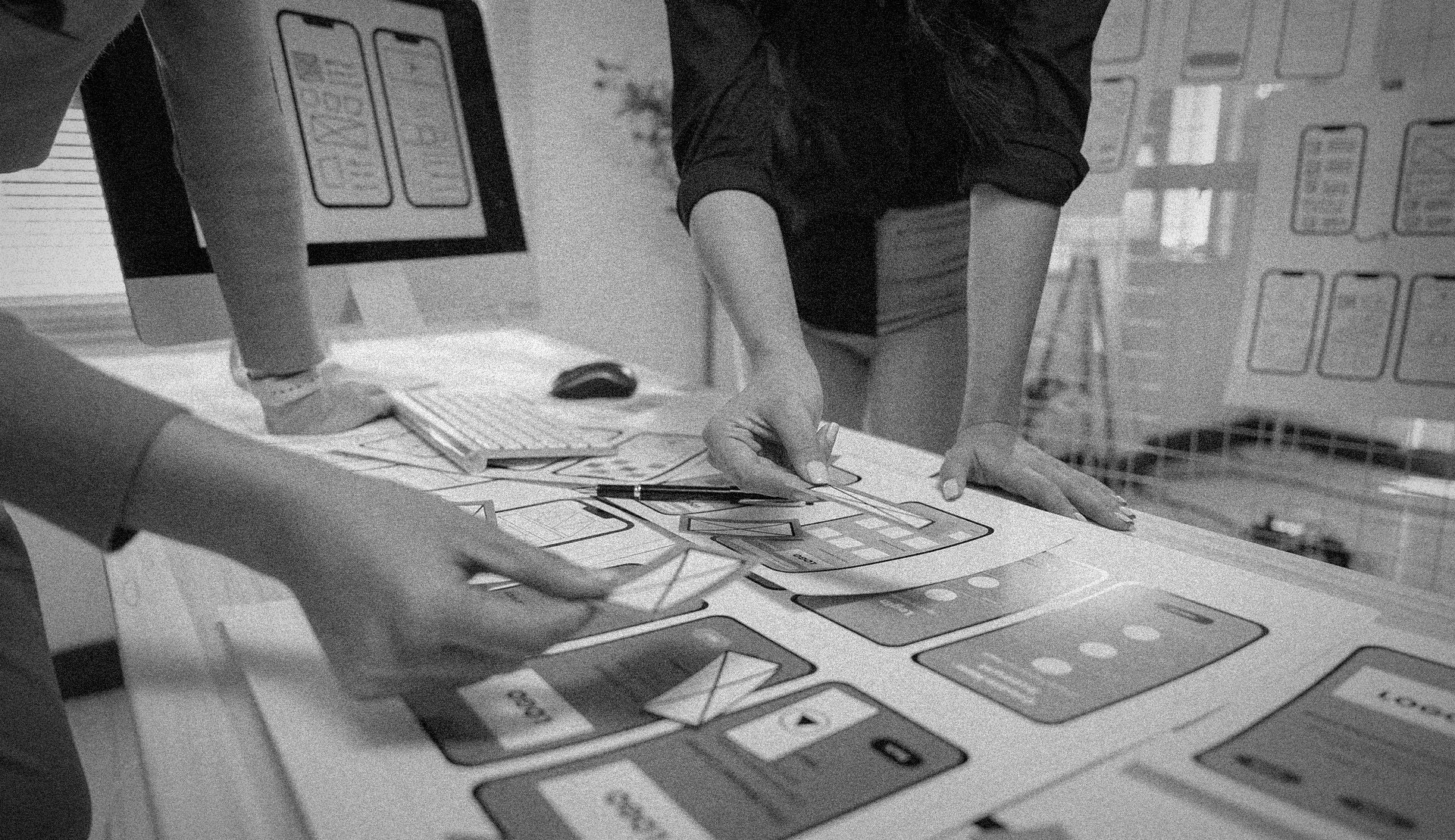 Creative agency team designing a mobile-optimized website with exceptional user experience strategies.